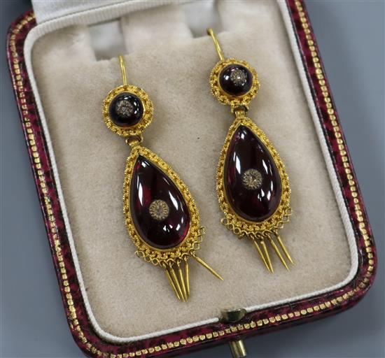 A pair of late Victorian etruscan style yellow metal, cabochon garnet and diamond set pear shaped tassel drop earrings,